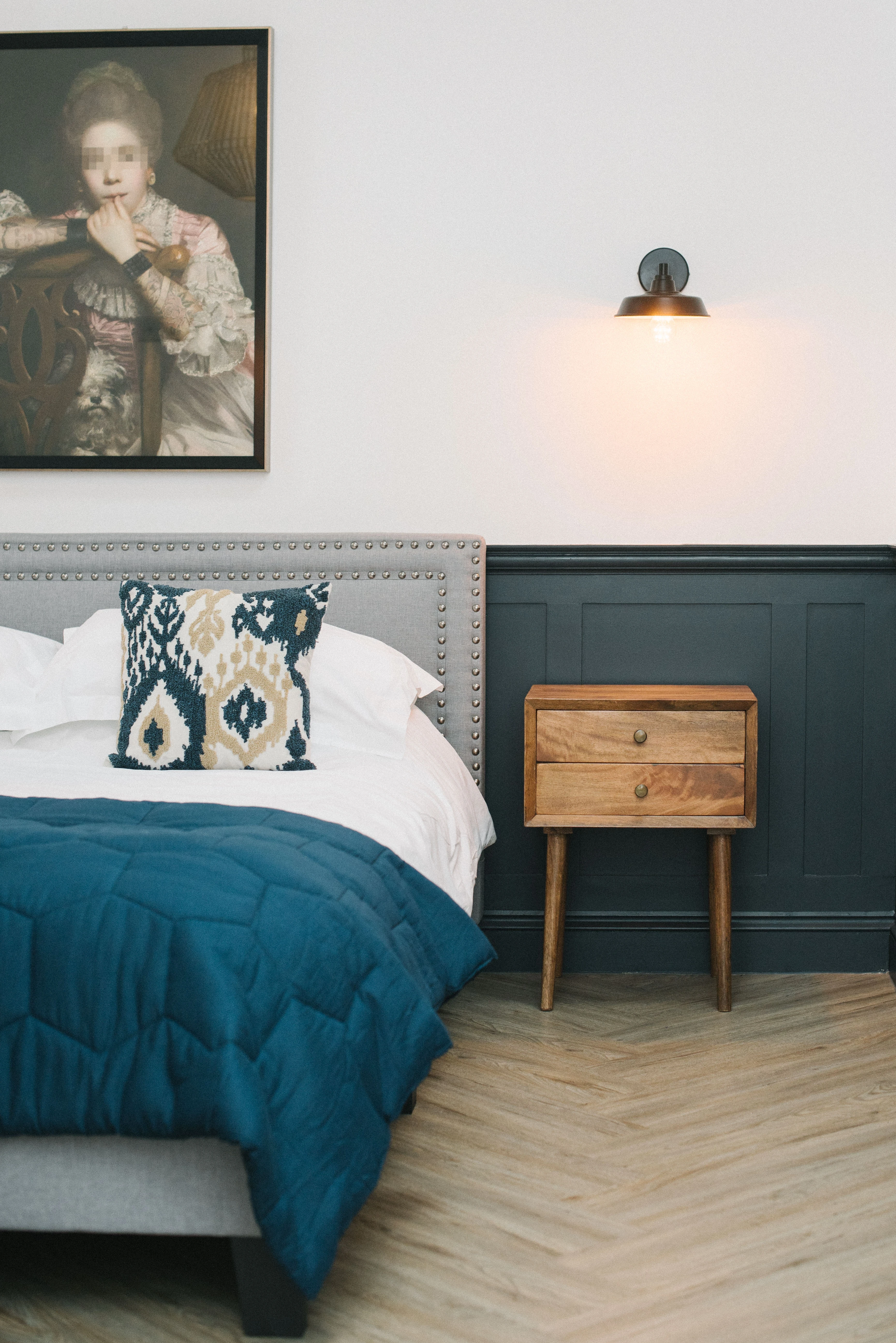 Montpelier Court bedroom — navy blanket, oak nightstand